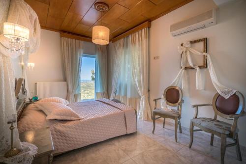 a bedroom with a bed and two chairs at Castelli by Vintage Travel in Lagópodhon