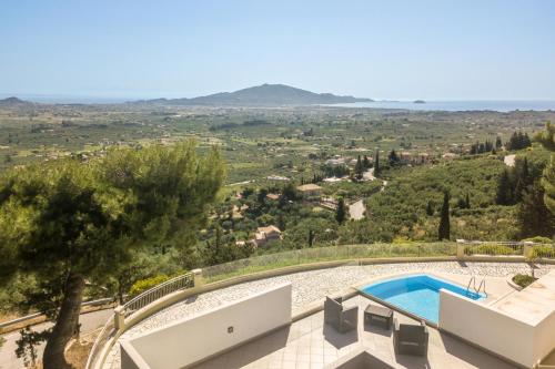 a villa with a swimming pool and a view at Castelli by Vintage Travel in Lagópodhon