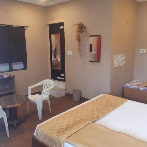 a bedroom with a bed and a desk and a chair at River View Homestsy in Vālpārai