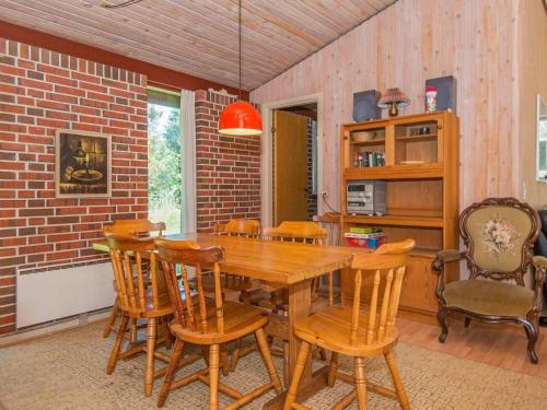 a dining room with a wooden table and chairs at 6 person holiday home in Ørsted-By Traum in Udbyhøj
