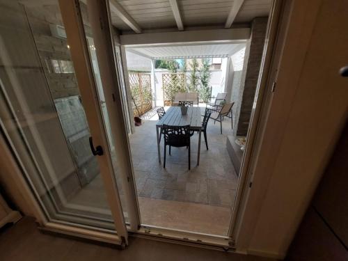 a dining room with a table and a glass door at CHIC house in Cascina