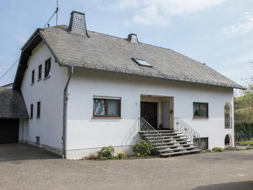 a white building with a staircase on the side at Lirstal Family Getaway in Lirstal