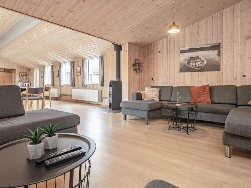 a living room with a couch and a table at 24 person holiday home in Øster Assels in Øster Assels