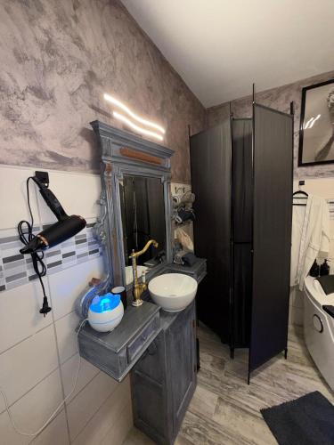 a bathroom with a sink and a mirror at Insinuances in Douzens