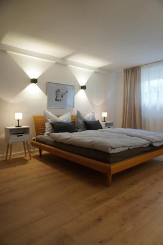 a bedroom with a large bed with two lamps at Landliebe Rheinhessen in Bingen am Rhein