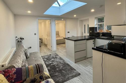 a kitchen and a living room with a couch at 2 Bed-Sleeps 5-Free Parking-Pet Friendly in High Wycombe