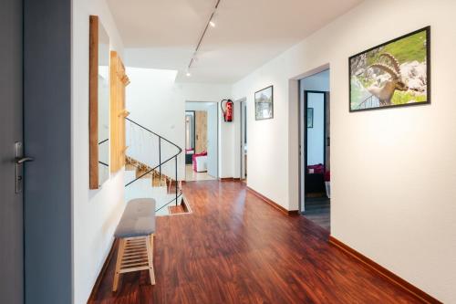 a hallway with stairs and a chair in a house at Ferienwohnung Wallis in Raggal