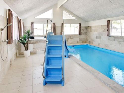 una piscina con uno scivolo blu in un bagno di Luxury Retreat in Asserbo - By Traum Ferienwohnungen a Frederiksværk