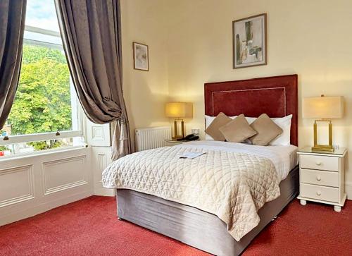 a bedroom with a large bed and a window at Morehampton Townhouse in Dublin