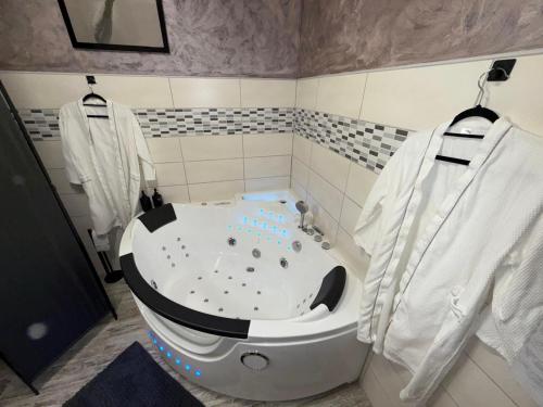 a bathroom with a bath tub in a room at Insinuances in Douzens
