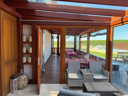 a house with a deck with tables and chairs at Penzion Kosík Tvrdonice in Tvrdonice