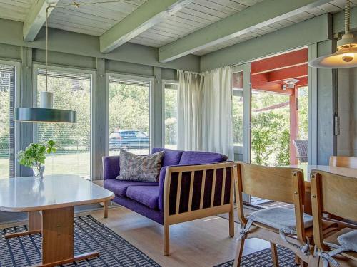 a living room with a purple couch and a table at Seaside Retreat in Allinge - By Traum Ferienwohnungen in Allinge