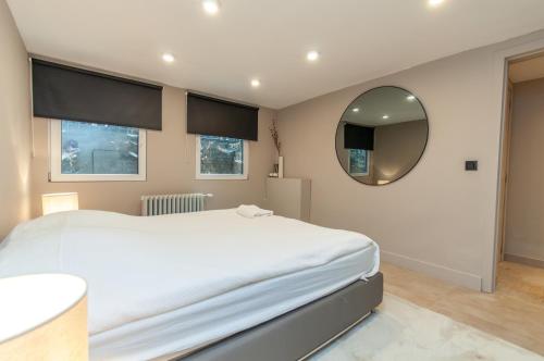a bedroom with a large bed and a mirror at Holiday Home in Antwerp in Antwerp