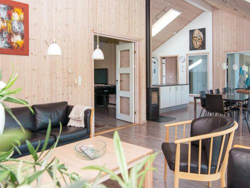 a living room with a couch and a table at 5 star holiday home in Odder in Odder