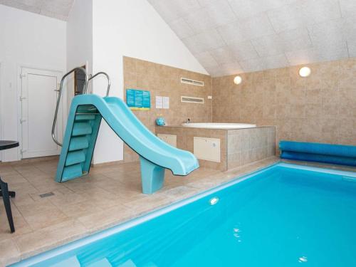 a bathroom with a swimming pool and a slide at 5 star holiday home in Odder in Odder