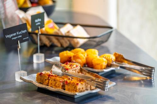 a table with plates of food on a counter at Best Western Plus Hotel Papenburg in Papenburg