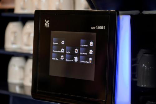 a close up of a microwave oven on a shelf at Best Western Plus Hotel Papenburg in Papenburg