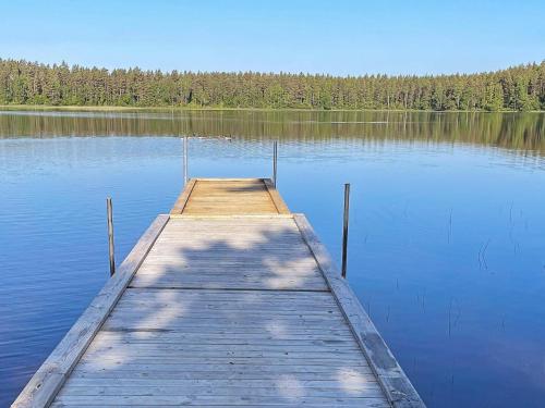 a wooden dock in the middle of a lake at 8 person holiday home in HÅCKSVIK-By Traum in Håcksvik