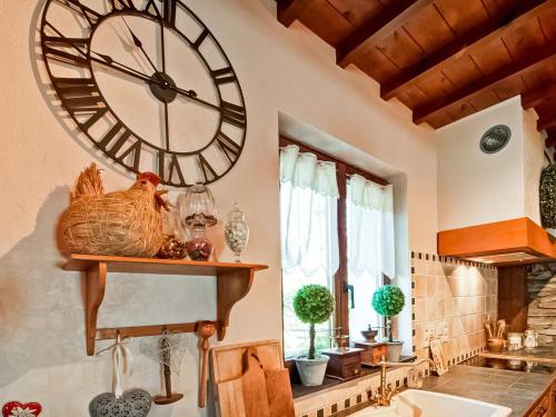 a large clock on the wall in a kitchen at Holiday Home in Lierneux with Garden in Lierneux