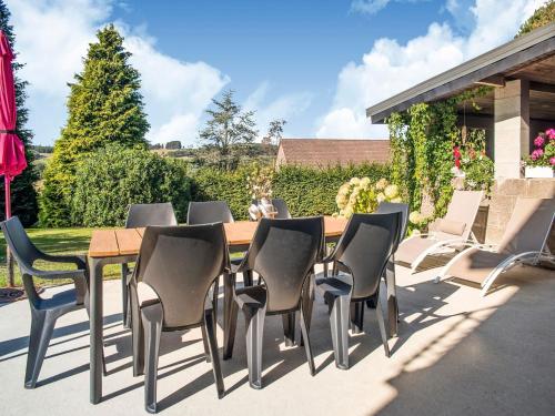 a wooden table and chairs on a patio at Holiday Home in Lierneux with Garden in Lierneux