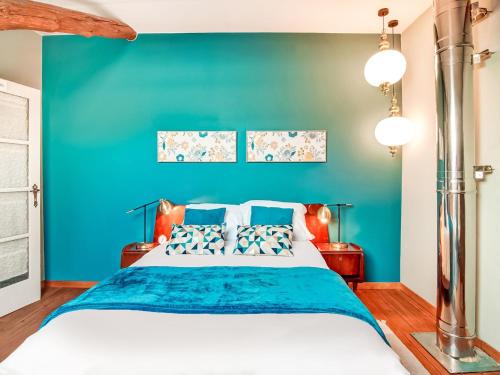 a blue bedroom with a large bed with blue walls at Holiday Home in Lierneux with Garden in Lierneux