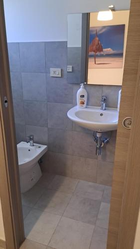 a bathroom with a sink and a toilet at BBcamere policlinico in Messina