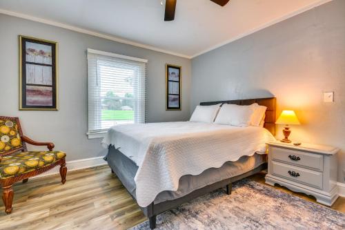 a bedroom with a bed and a chair and a window at Home 1 Mi to Dtwn and High Point University! in High Point