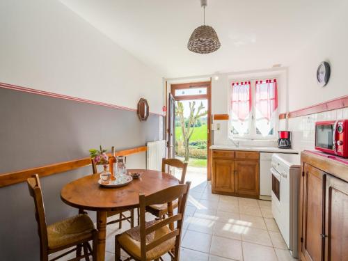 a kitchen with a table and chairs in a kitchen at Forest View Home in Loubejac in Villefranche-du-Périgord