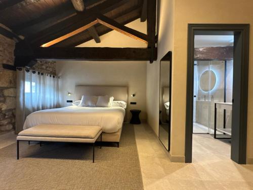 a bedroom with a large bed and a large window at Hotel El Paraíso del Pas in Barcenilla