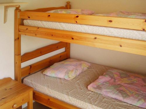 two bunk beds in a room with a table at 4 person holiday home in Byxelkrok-By Traum in Byxelkrok