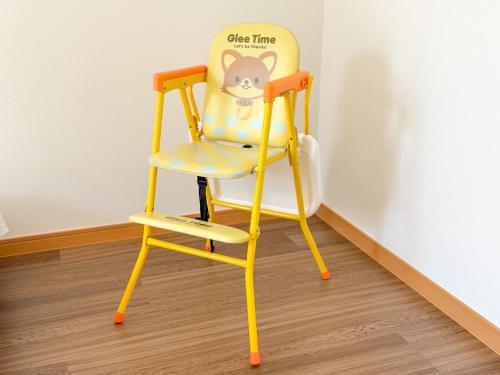 a yellow chair with a cat painted on it at KATAYAMA Base in Takasaki