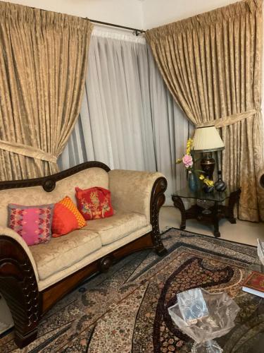 a living room with a couch and a table at sheen house in Rawalpindi