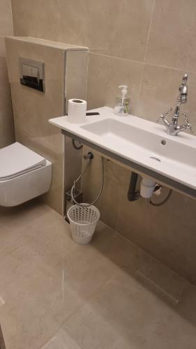 a bathroom with a sink and a toilet at villa pools bbq lounge in Oujda