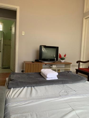 a bedroom with a bed with a tv on it at Casa 420 in Diamantina