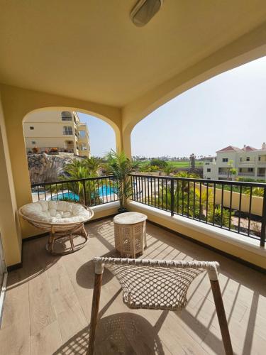 a balcony with a view of the ocean from a building at the green holes in San Miguel de Abona
