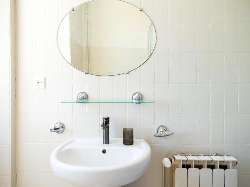 a white bathroom with a sink and a mirror at Holiday home with pool in Coubjours in Coubjours