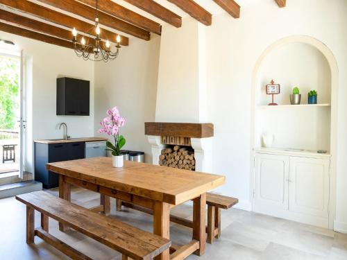 a kitchen with a wooden table and benches at Holiday home with pool in Coubjours in Coubjours