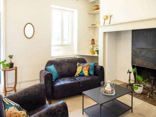 a living room with a couch and a table at Holiday home with pool in Coubjours in Coubjours
