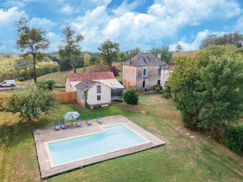an aerial view of a house with a swimming pool at Holiday home with pool in Coubjours in Coubjours