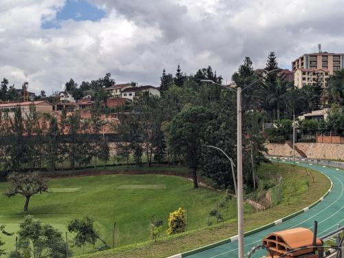 a golf course on a hill with a street light at Room in Art studio in Kigali