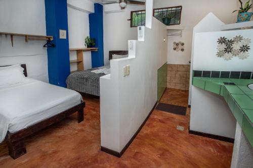 a small room with two beds and a bathroom at Villas Jacquelina in Quepos