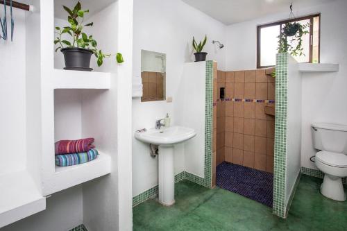 a bathroom with a sink and a toilet at Villas Jacquelina in Quepos