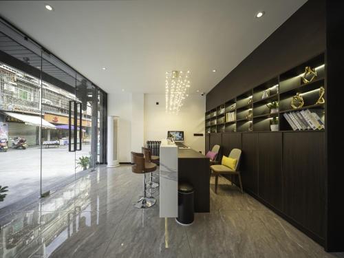 a lobby with a table and chairs in a building at Fenghuang Ancient Town Tinglan Waterfront High-end B&B in Fenghuang