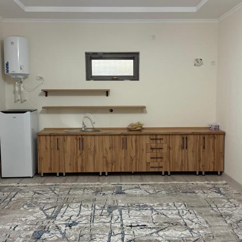 a kitchen with a wooden counter and a sink at Nurata Ecotourism Guesthouse in Yukary-Ukhum