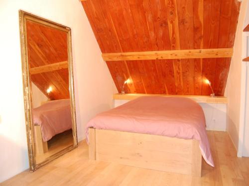 a bedroom with a bed and a mirror at Lovely mansion with fenced garden in Baguer-Morvan