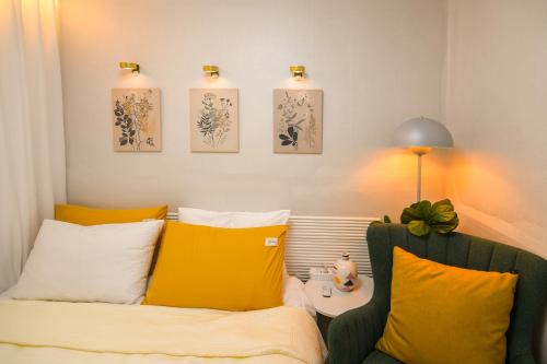 a living room with a couch and yellow pillows at Our Stay in Seoul