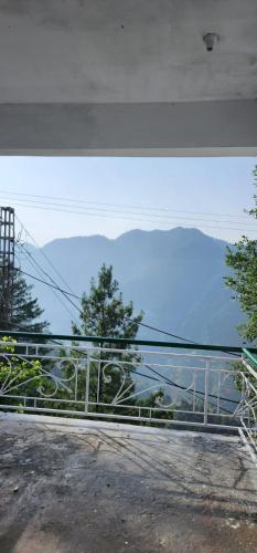 a view of a mountain view from a balcony at Mezbaan guest house in Nathia Gali