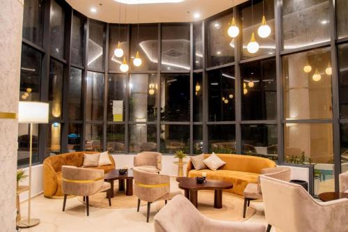 a lobby with a couch and tables and chairs at Stylish 2-Bedroom Trizen Retreat in Prime Location in Colombo