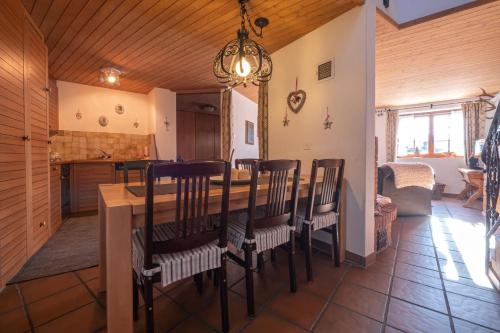a kitchen and dining room with a table and chairs at Duplexwohnung in den Alpen in Riederalp