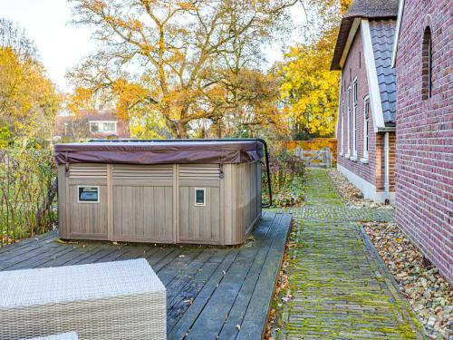 a garage on a deck next to a building at Farmhouse Nijverdal near Sallandse Heuvelrug in Nijverdal